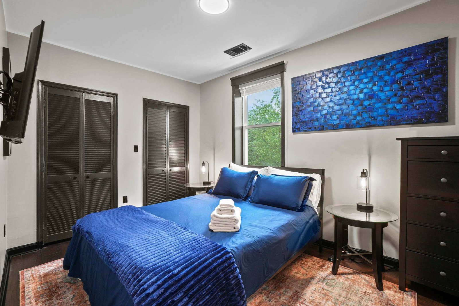 Queen bedroom with plush linens and room-darkening shades