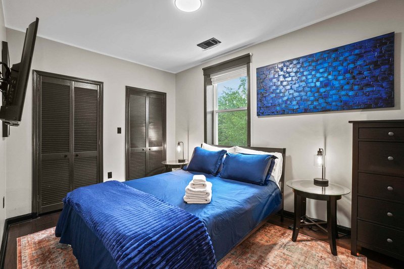 Queen bedroom with plush linens and room-darkening shades